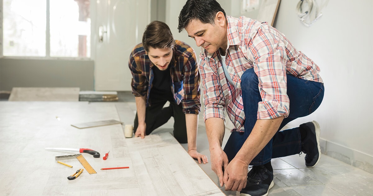 Two people doing floor installation