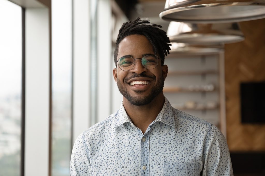 Young man smiling in an apartment