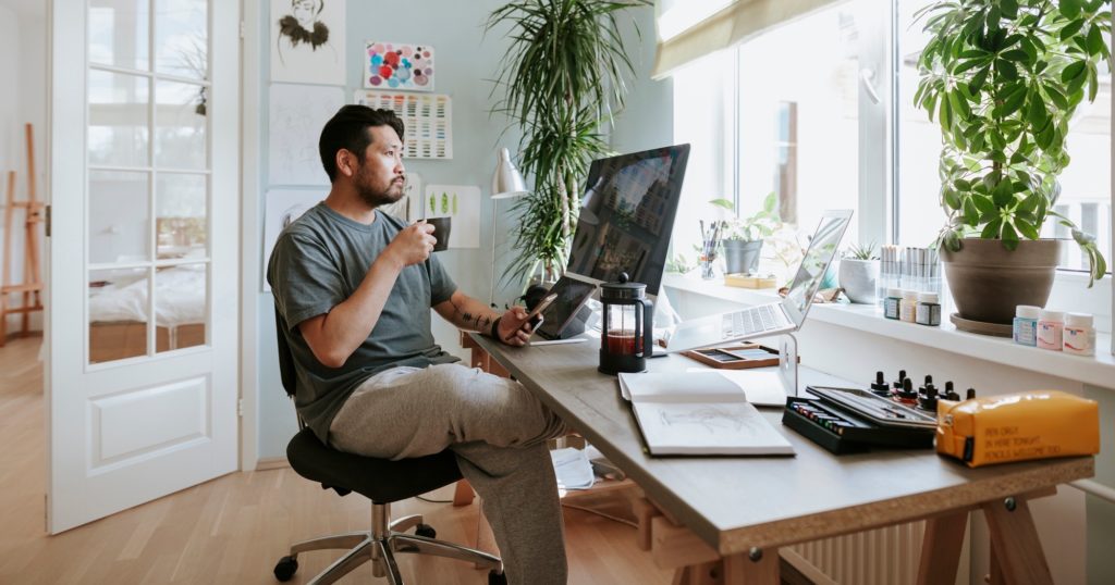 Man drinking coffee and working from home at a multifamily property