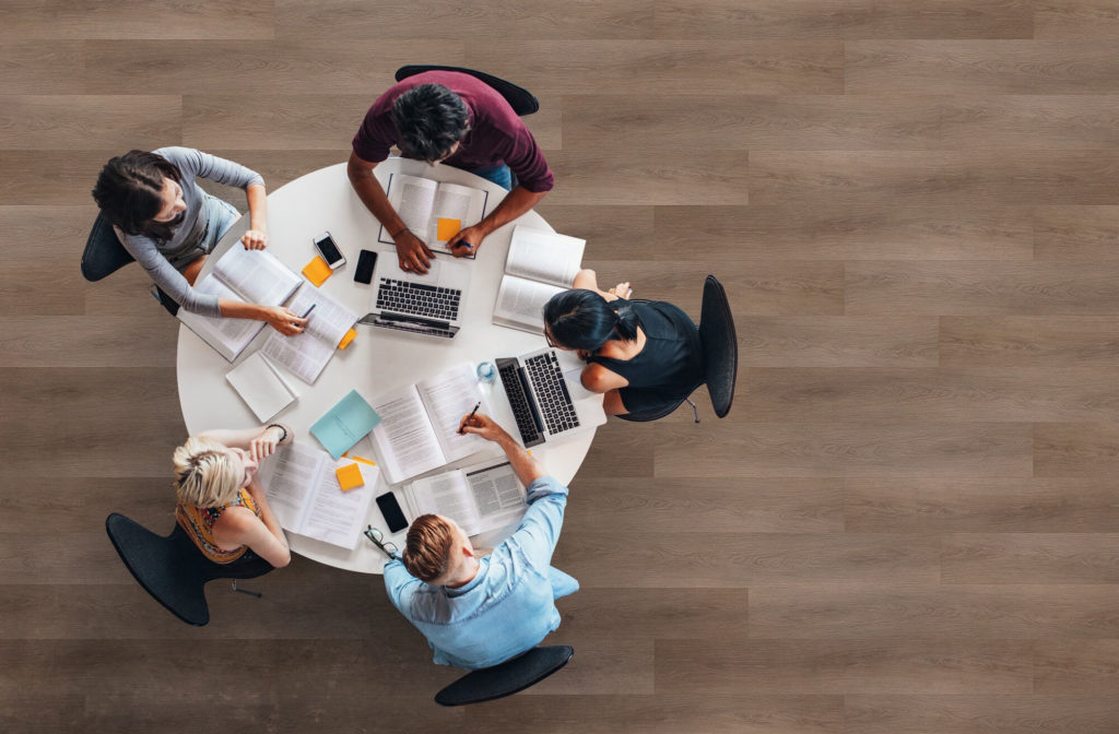 Group of people doing remote work in a common area of a multifamily property