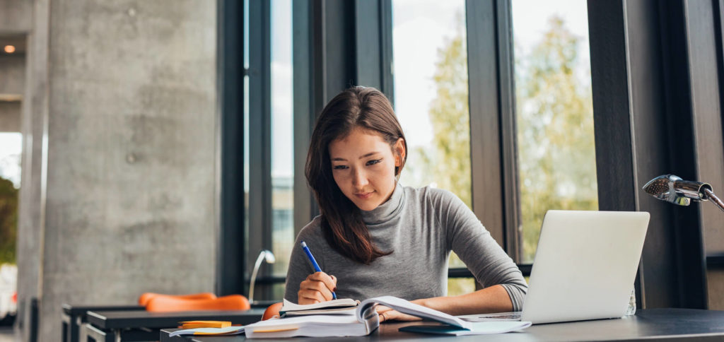 Woman working remote in an apartment office space