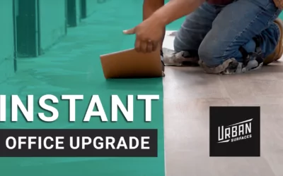 Person installing InstaGrip vinyl flooring in a warehouse office hallway