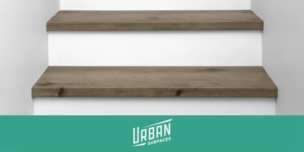 Urban Surfaces logo with All-In-One WPC Stair Treads installed on a staircase.
