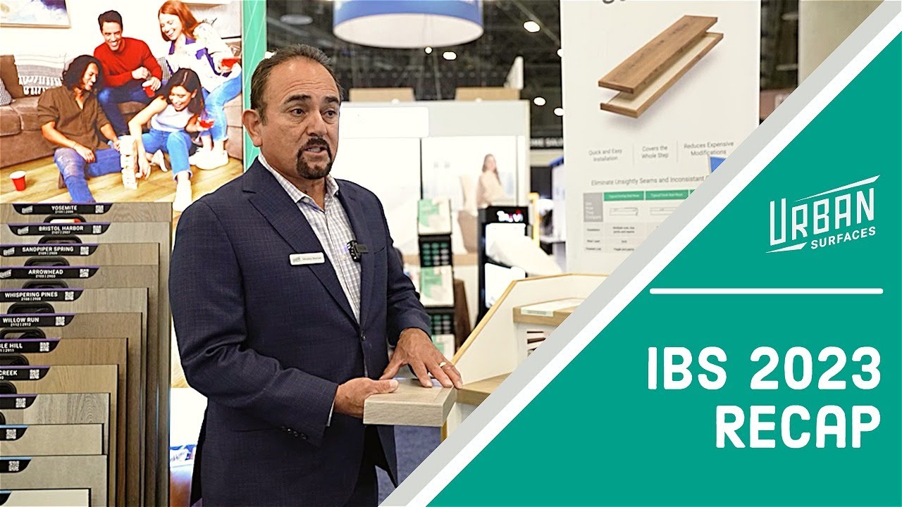 Business man Mickey Macias demonstrating vinyl flooring products in the Urban Surfaces booth at IBS 2023.