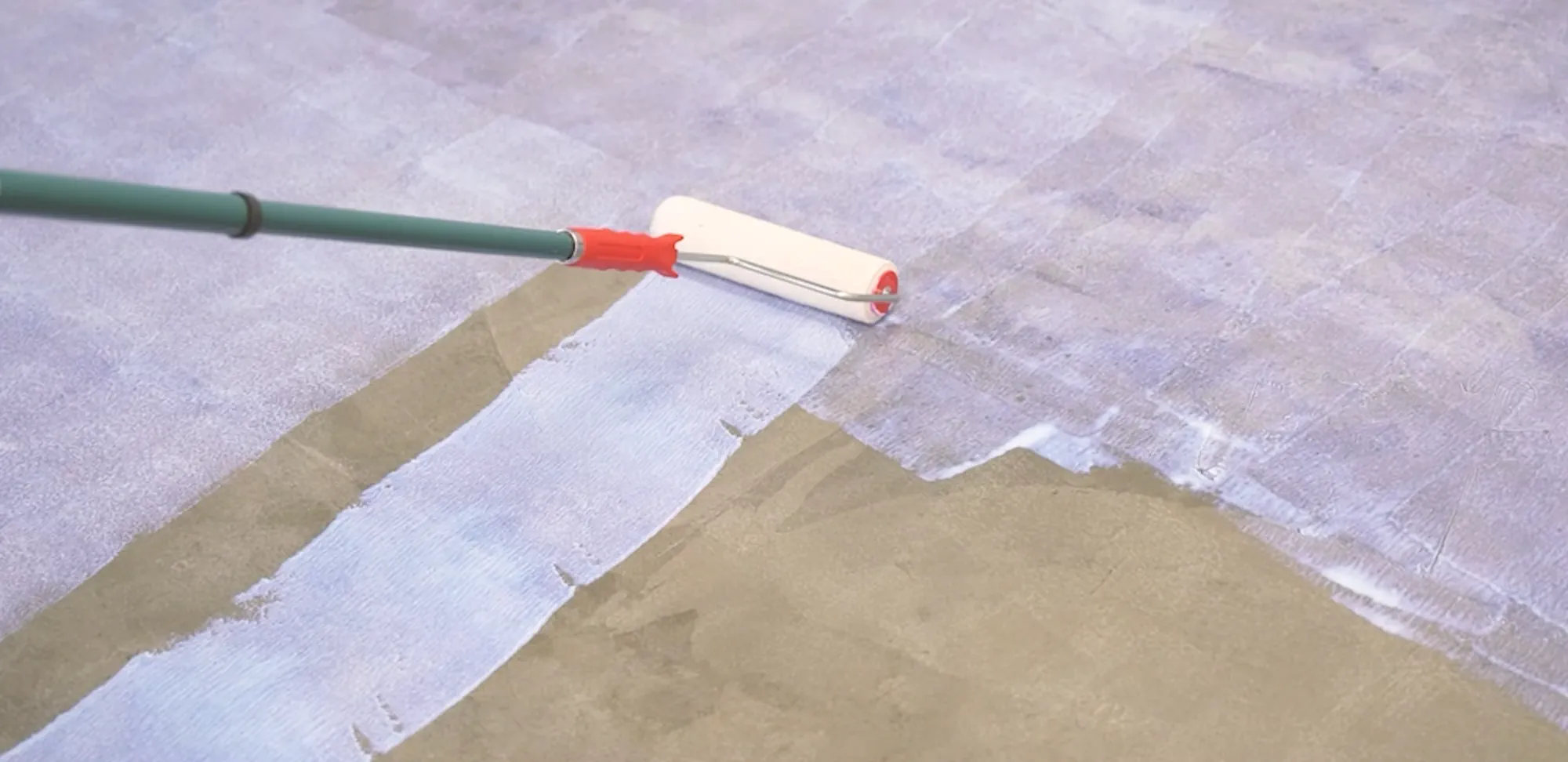 Roller applying Traction Subfloor Grip Coating to a concrete subfloor.