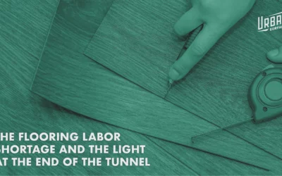 Hand cutting vinyl plank flooring. Title: The Flooring Labor Shortage and the Light at the End of the Tunnel.