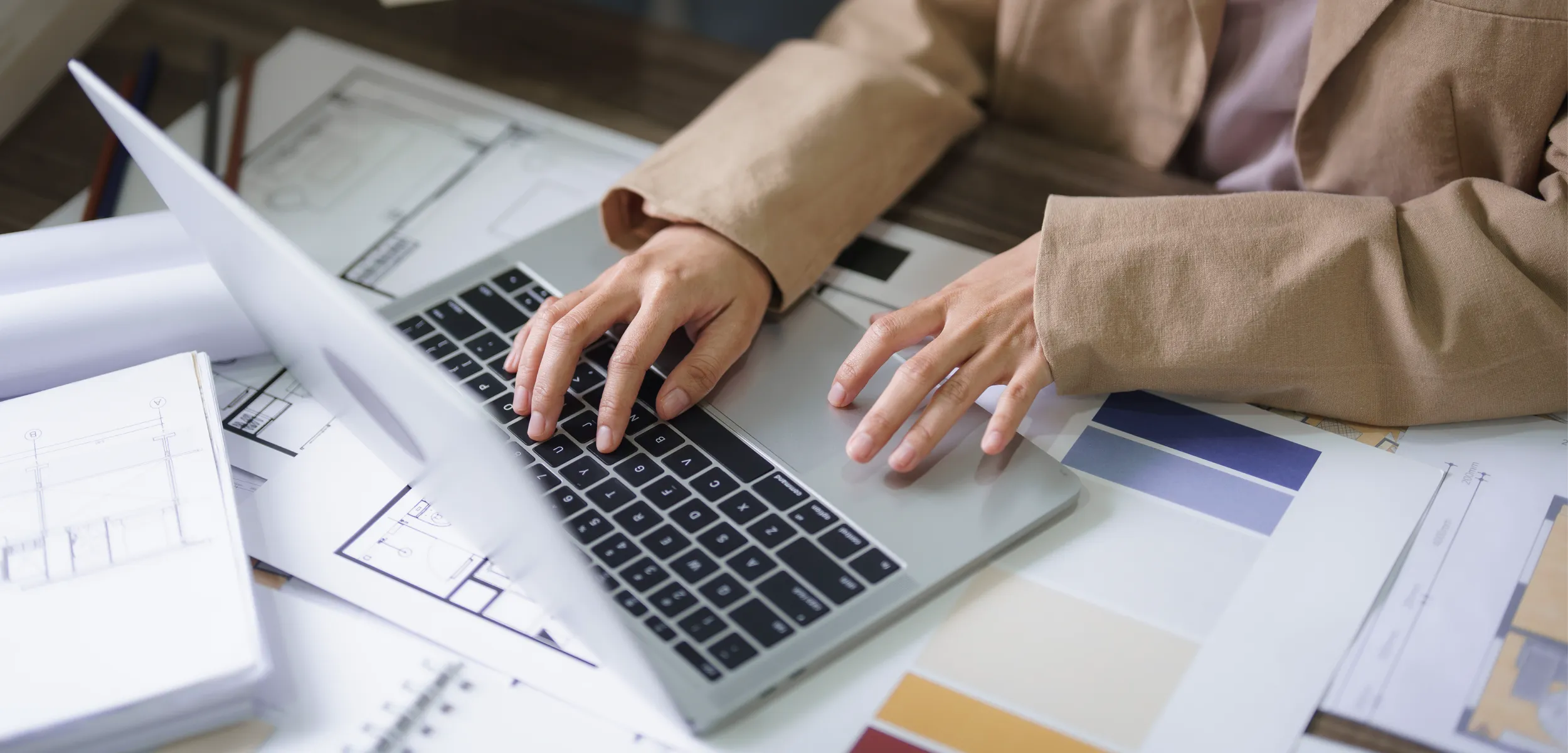 Woman working on a laptop to create an apartment listing.