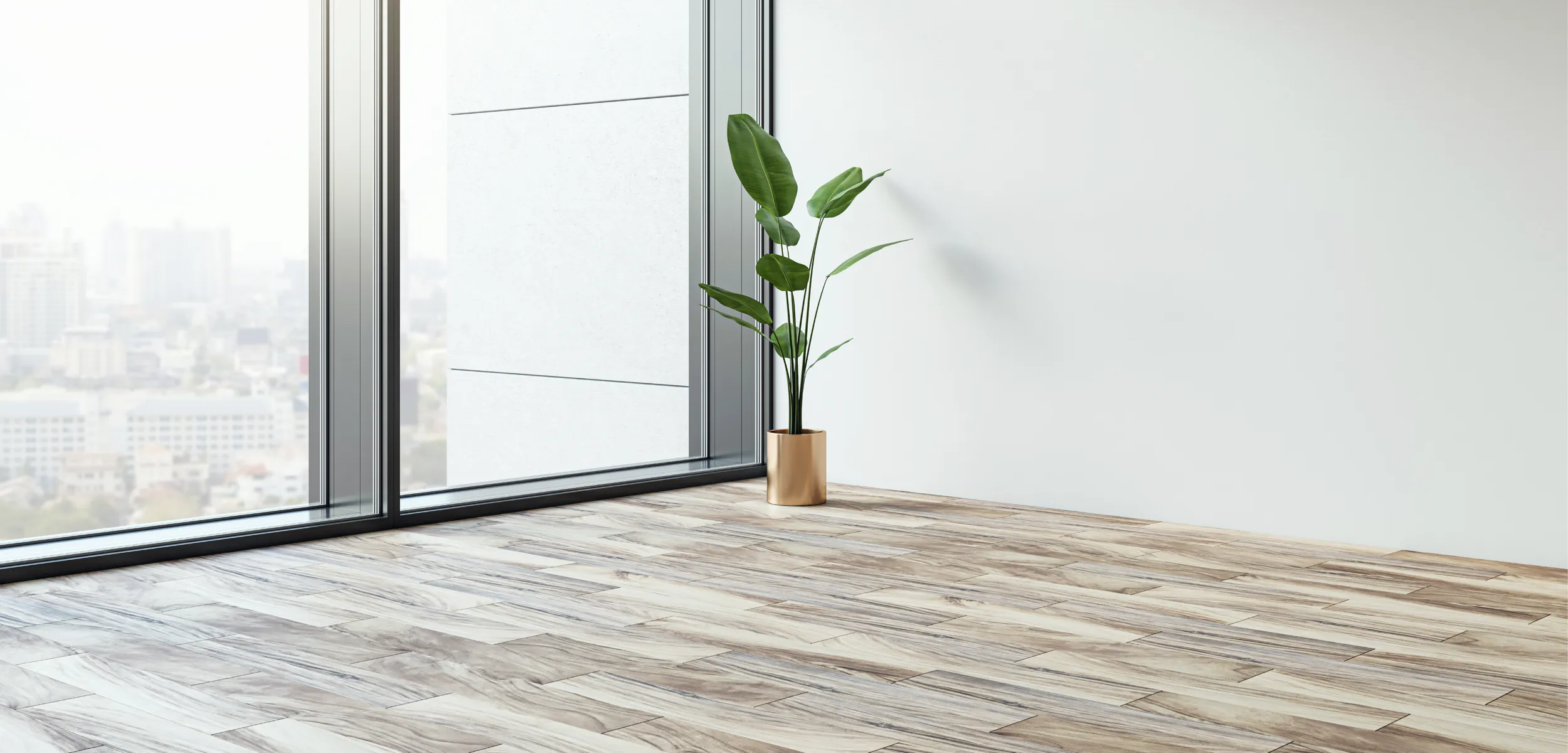Empty apartment home with luxury vinyl flooring, a plant, and a view of the city.