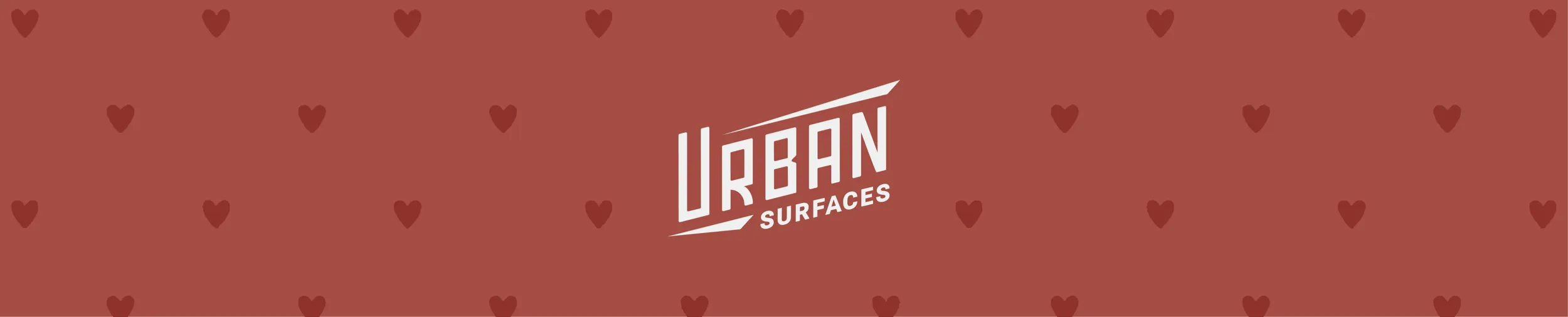 Urban Surfaces logo on red background with hearts for Valentine's Day.