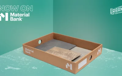 A cardboard Material Bank box with flooring samples in it. A "Now on Material Bank" badge in the top left. An Urban Surfaces logo in the top right.